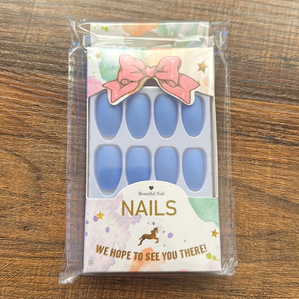 Baby blue glue on nails.